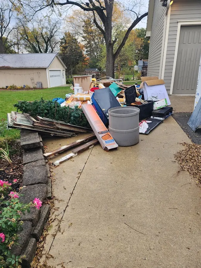 Dumpster being loaded with debris for 12 Yard Dumpster Rental in Bridgeville